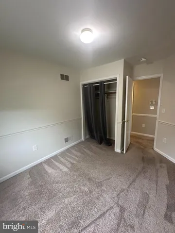 an empty room with a mirror