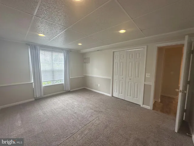an empty room with a space and windows