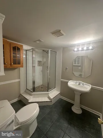 a bathroom with a toilet sink and shower