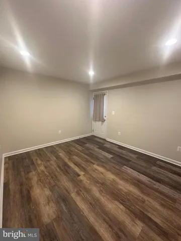 a view of an empty room and wooden floor