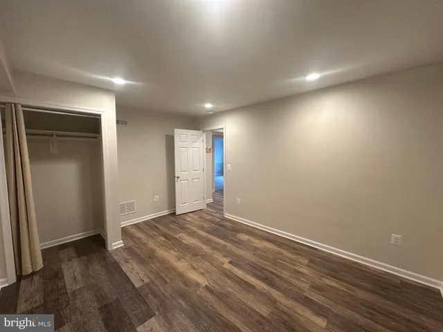 a view of room with wooden floor
