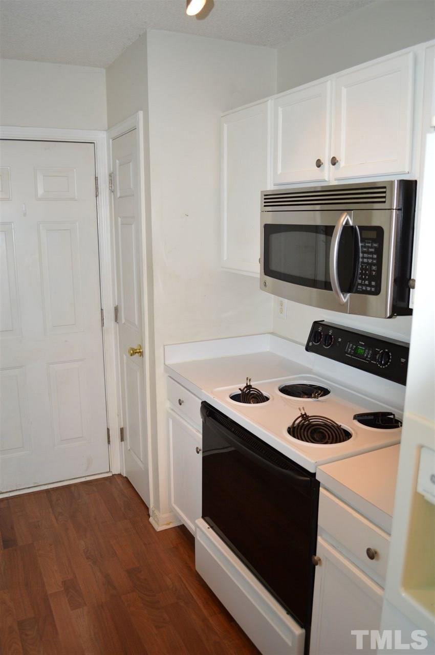 5116 Gable Ridge Drive Durham, NC 27713 - Photo 4 of 16 a kitchen with a stove and a microwave