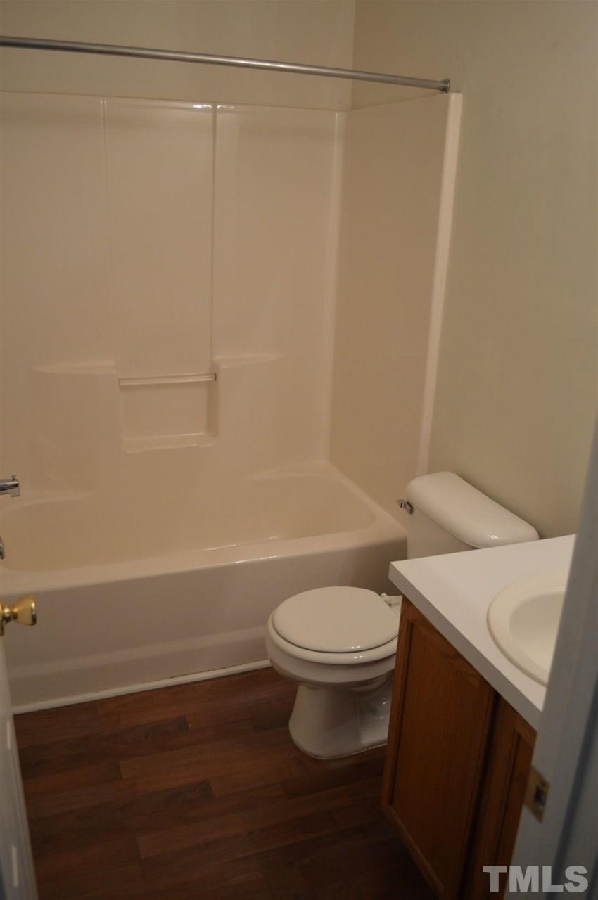 5116 Gable Ridge Drive Durham, NC 27713 - Photo 10 of 16 a bathroom with a sink a toilet and shower