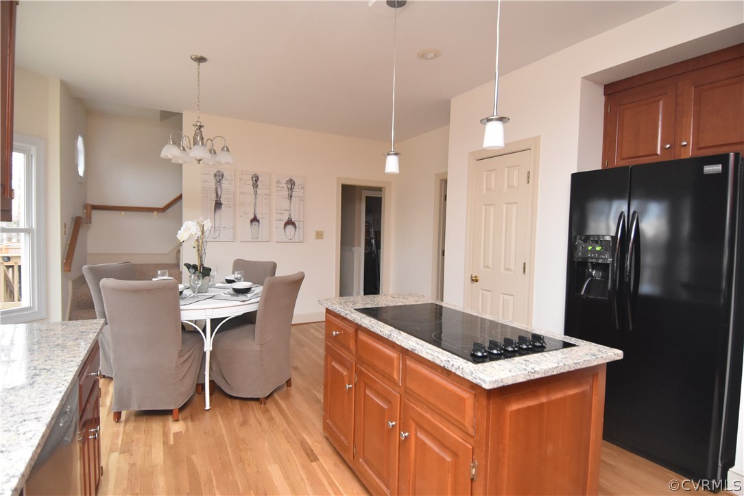13806 Beechwood Point Road Midlothian, VA 23112 - Photo 21 of 48 a kitchen with granite countertop a refrigerator a stove a sink dishwasher a dining table and chairs with wooden floor