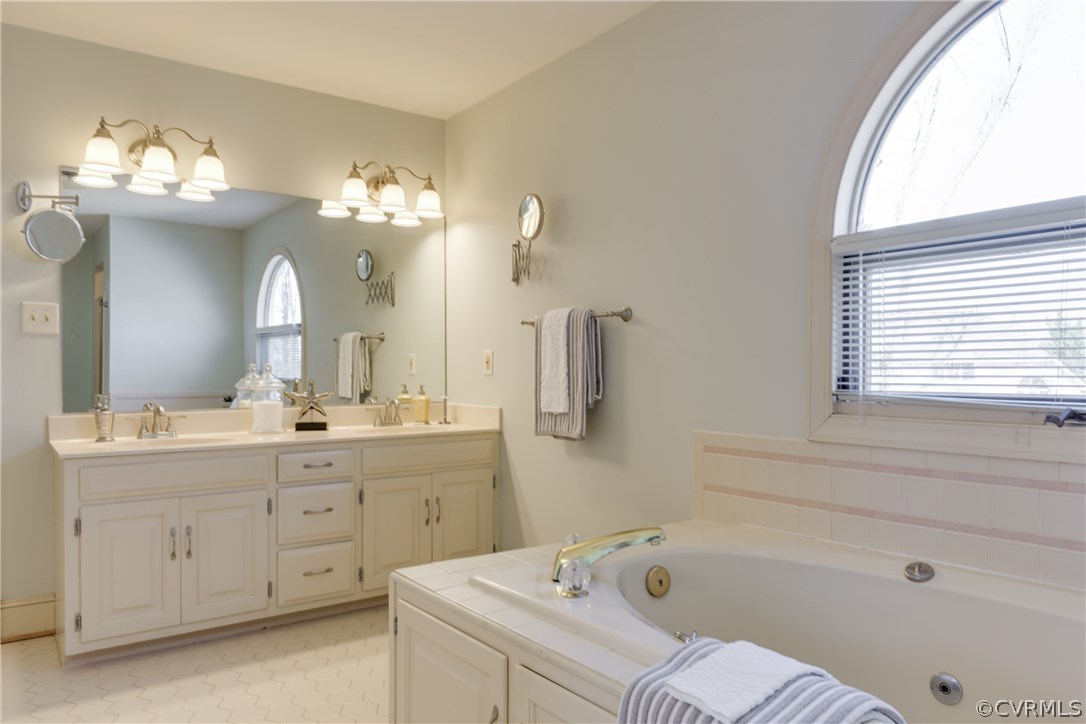 13806 Beechwood Point Road Midlothian, VA 23112 - Photo 32 of 48 a bathroom with a bathtub a sink and a window