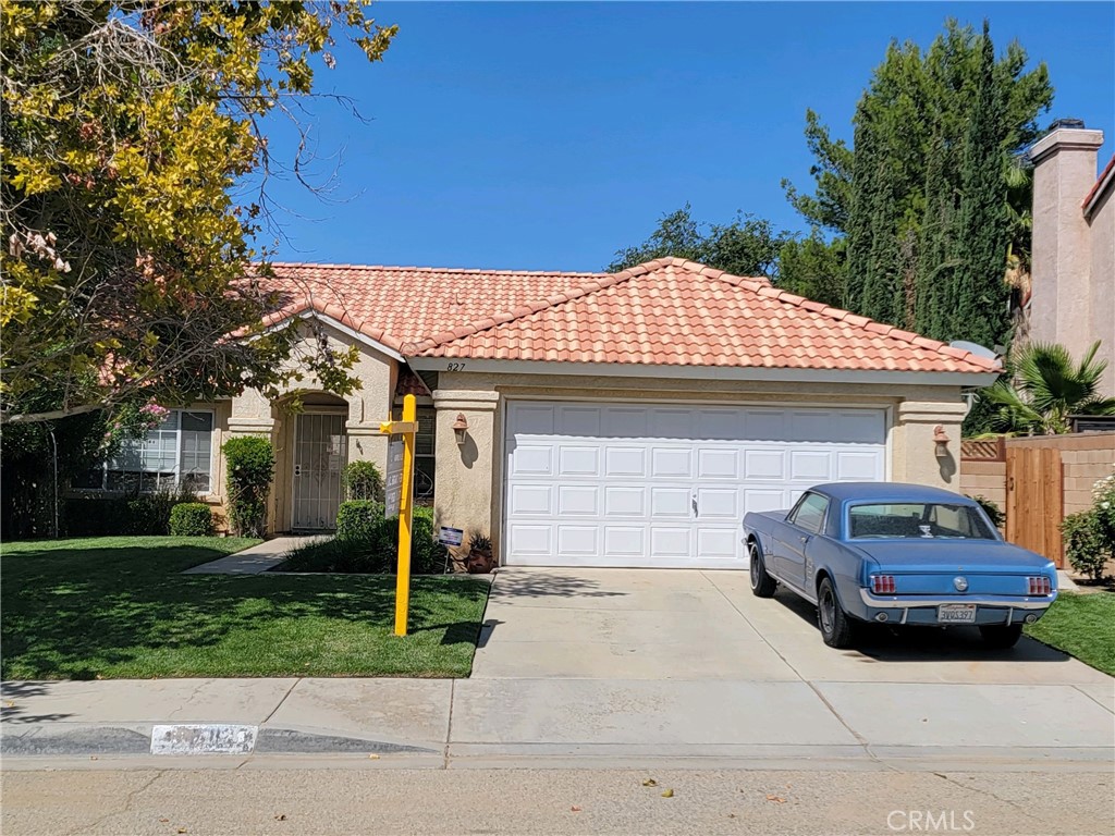 827 East E Avenue Lancaster, CA 93535 - Photo 1 of 1 a front view of a house with a garden