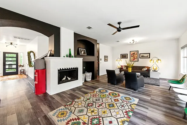 a living room with furniture and a fireplace