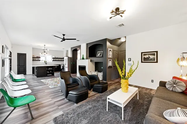 a living room with furniture and a wooden floor