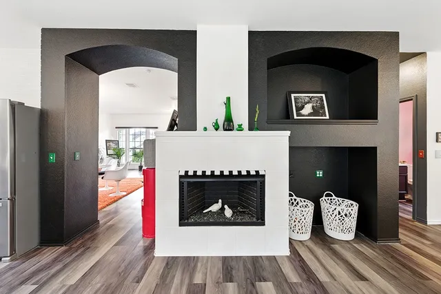 a living room with a fireplace and a wooden floor