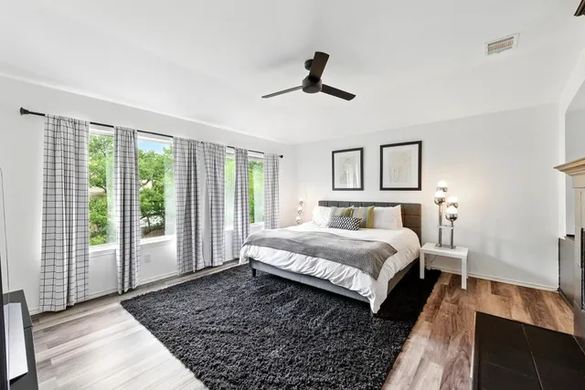 a large bedroom with a bed and large window