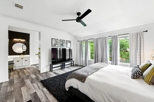 a bedroom with a bed and wooden floor