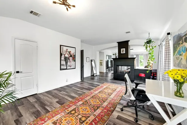a living room with furniture and a fireplace