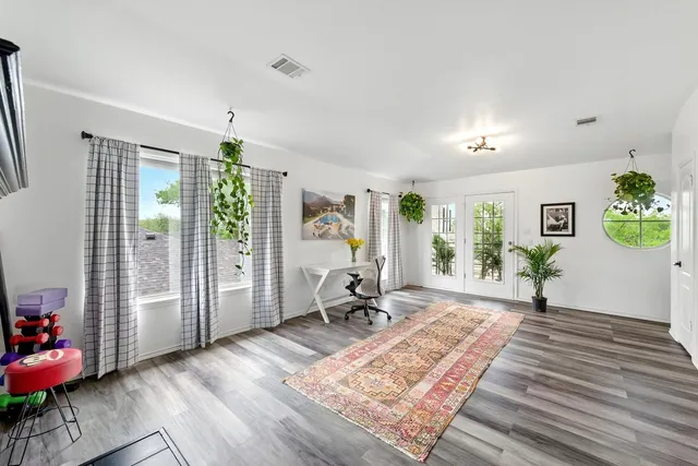 a living room with furniture and wooden floor
