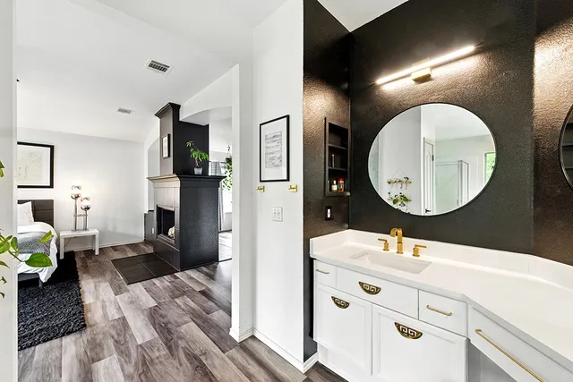 a bathroom with a double vanity sink and a mirror