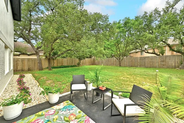 a view of backyard with seating area and green space