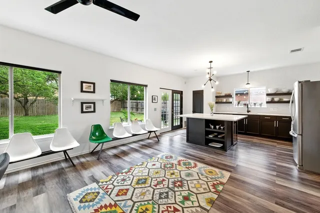 a living room with furniture and a floor to ceiling window