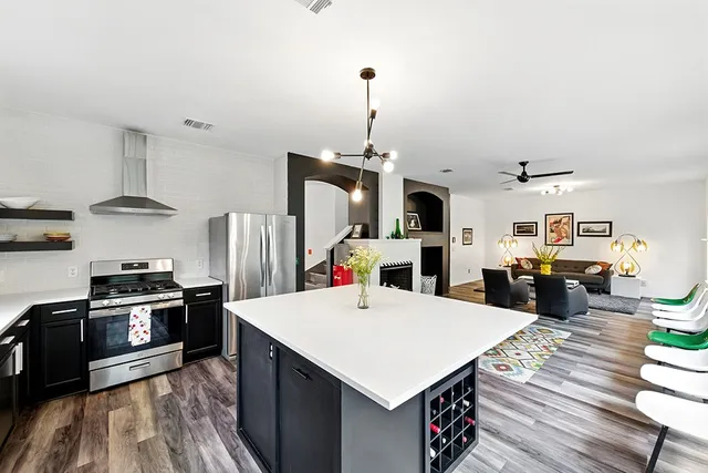 a kitchen with sink refrigerator and wooden floor