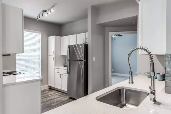 a kitchen with a sink stove and cabinets