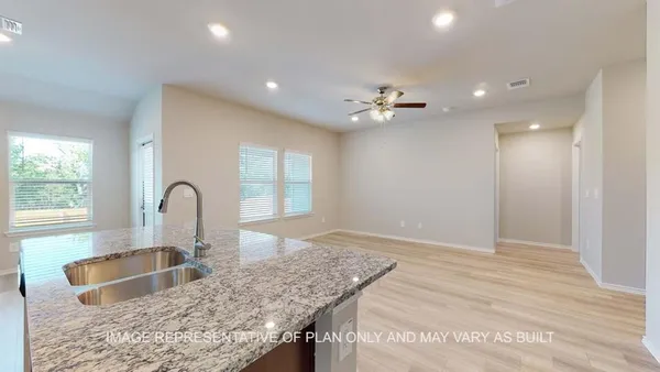 a kitchen with granite countertop a sink and a large window