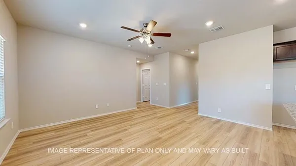 an empty room with fan and a ceiling fan