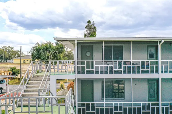 a view of a house with wooden floor and a floor to ceiling window
