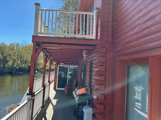 a view of a balcony with chairs and wooden floor