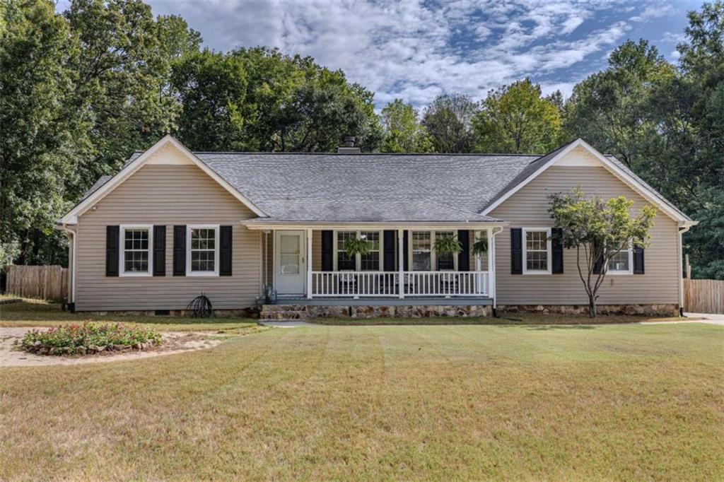 a front view of a house with a garden