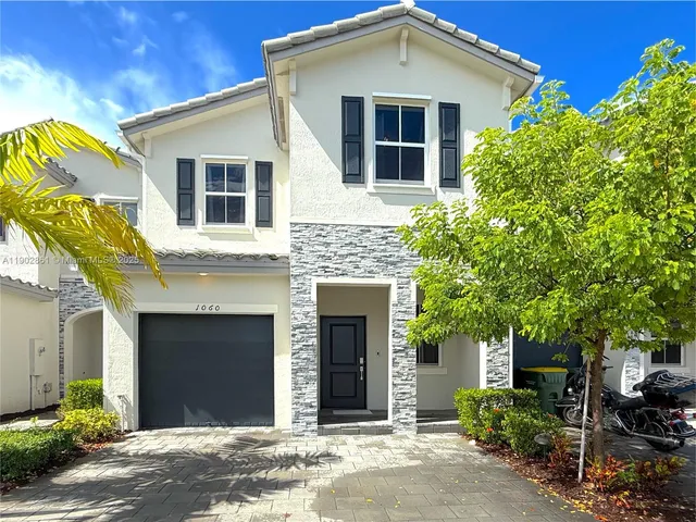a front view of a house with yard