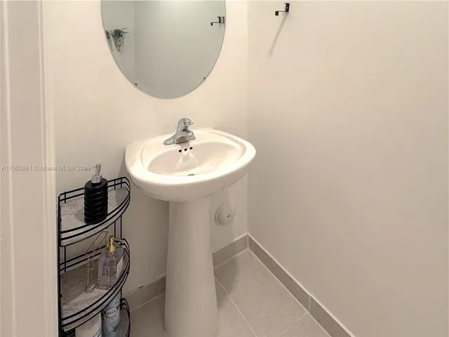 a bathroom with a sink a toilet and mirror