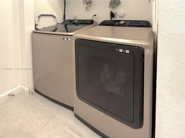 a close view of a utility room with washer and dryer