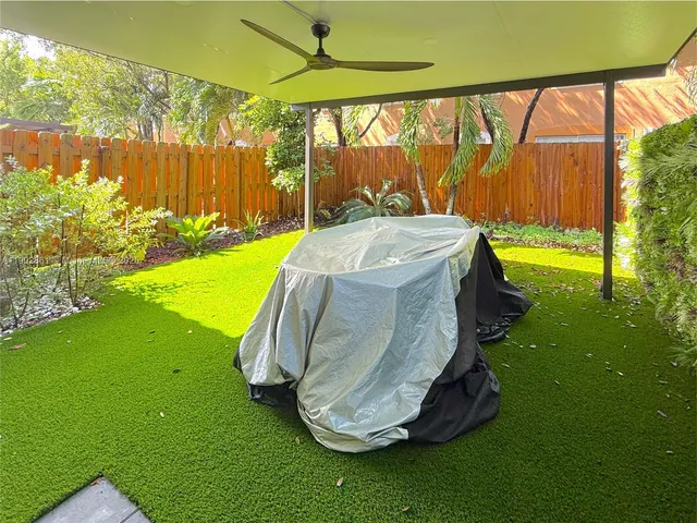 a view of a backyard with swimming pool