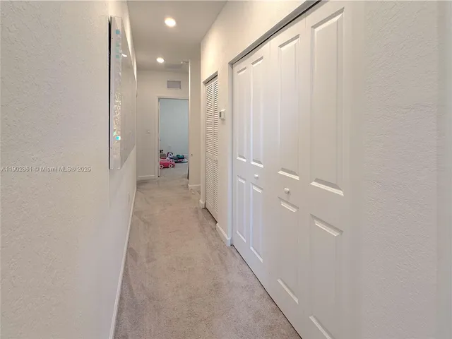 a view of a hallway with closet