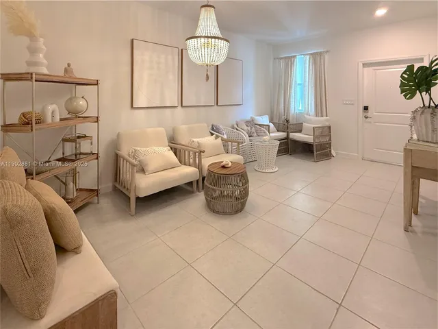 a living room with furniture a couch and potted plant