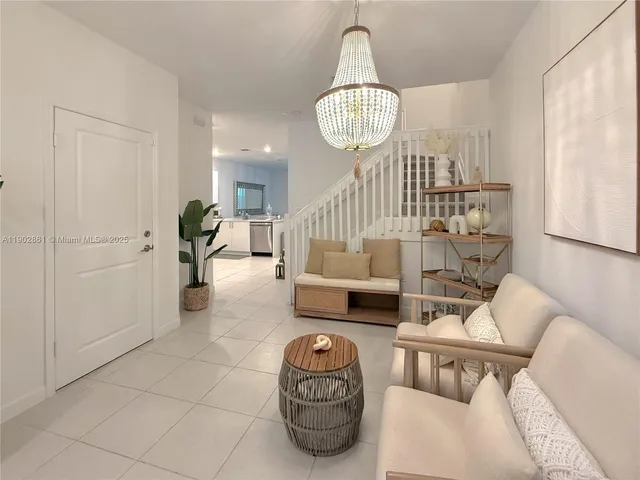 a living room with furniture a chandelier and a chandelier