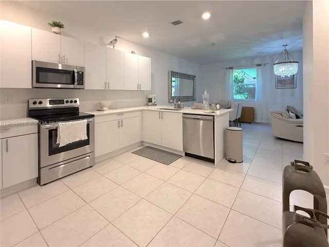 a kitchen with a sink cabinets and appliances
