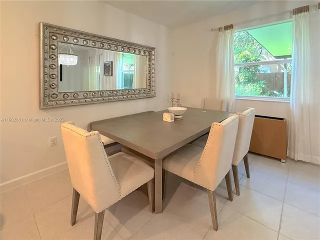 a view of a dining room with furniture and a window