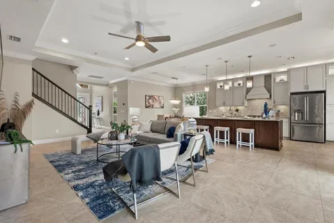 a living room with lots of furniture and kitchen view