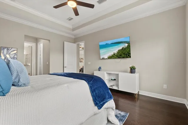 a spacious bedroom with a bed and a chandelier