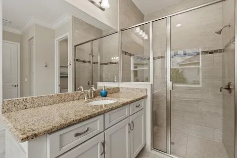 a bathroom with a granite countertop sink and mirror