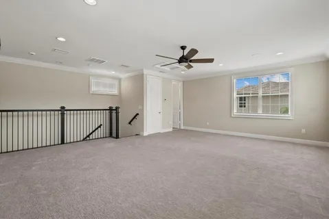 a view of a livingroom with a ceiling fan and window