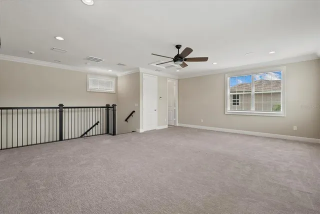 a view of a livingroom with a ceiling fan and window