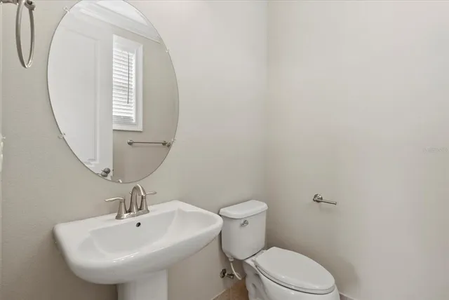 a bathroom with a sink a mirror and a toilet