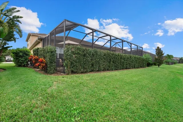 a view of a house with a yard and potted plants