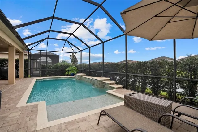 a view of a swimming pool with a patio