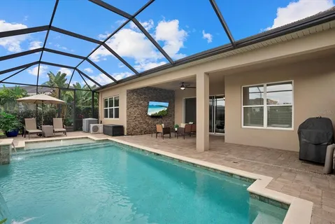 a view of a backyard with table and chairs under an umbrella