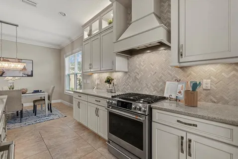 a kitchen with stainless steel appliances granite countertop a stove and a sink