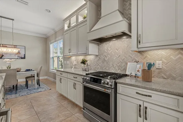 a kitchen with stainless steel appliances granite countertop a stove and a sink