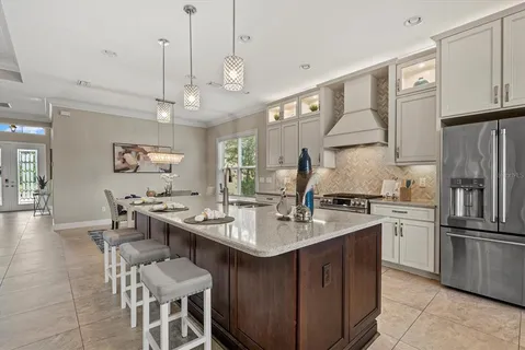 a kitchen with center island a sink stainless steel appliances and cabinets