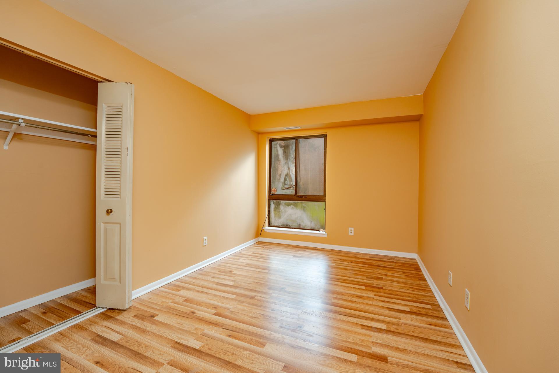 254 Vail Court, Unit 1504 Mays Landing, NJ 08330 - Photo 13 of 22 a view of an empty room with wooden floor and a window