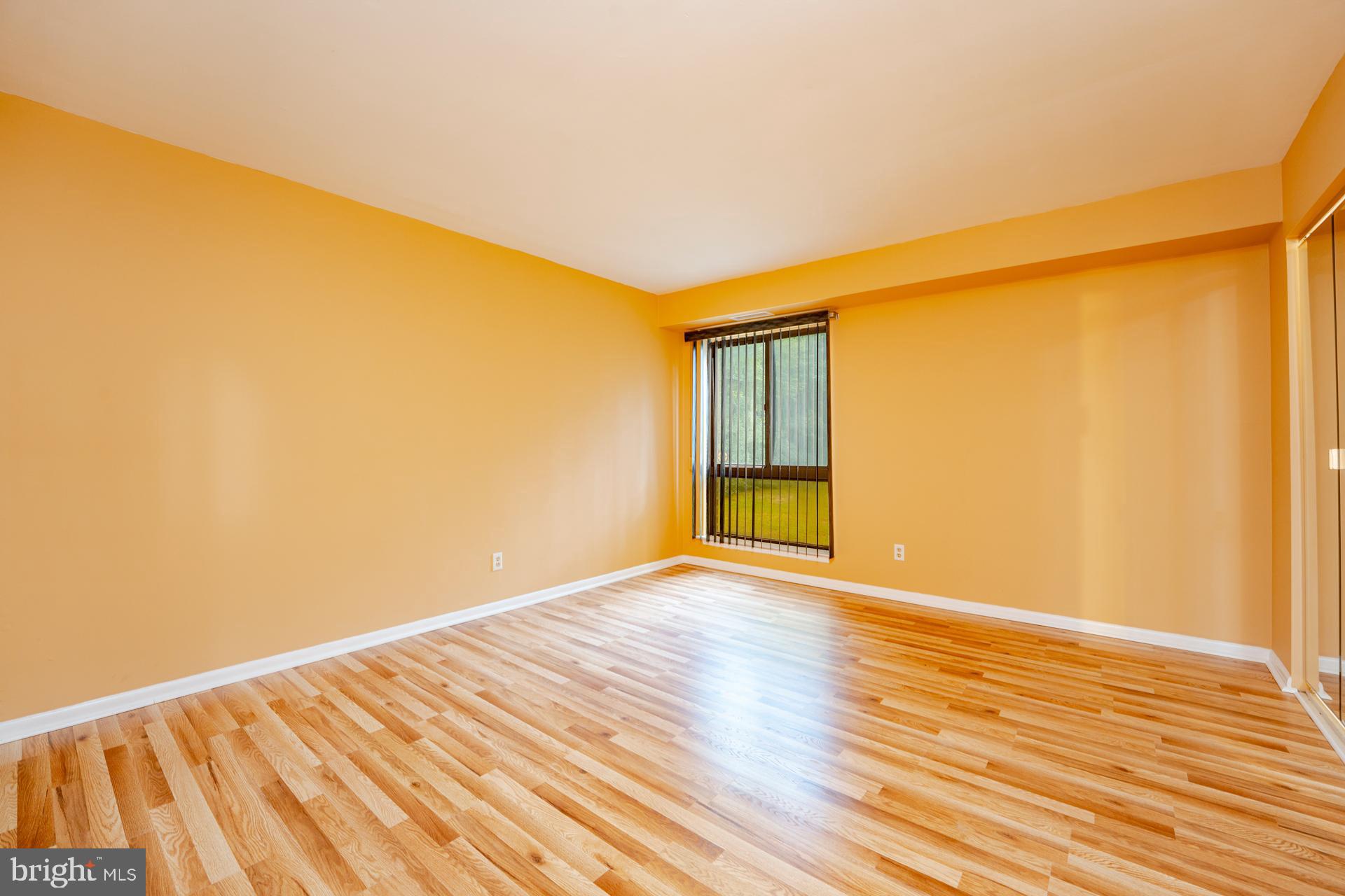 254 Vail Court, Unit 1504 Mays Landing, NJ 08330 - Photo 15 of 22 a view of an empty room with wooden floor and a window